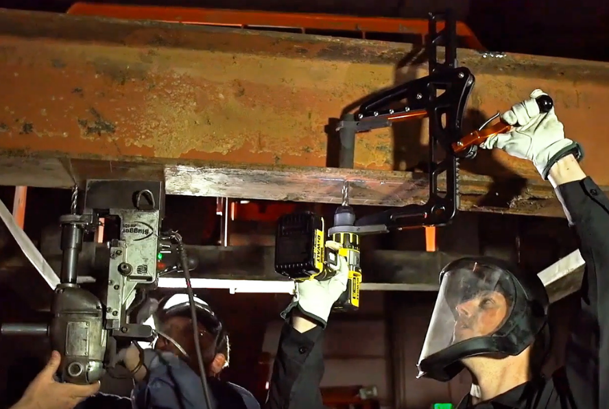 Shop workers drilling on metal beam with a mag drill and a rapidrill side by side