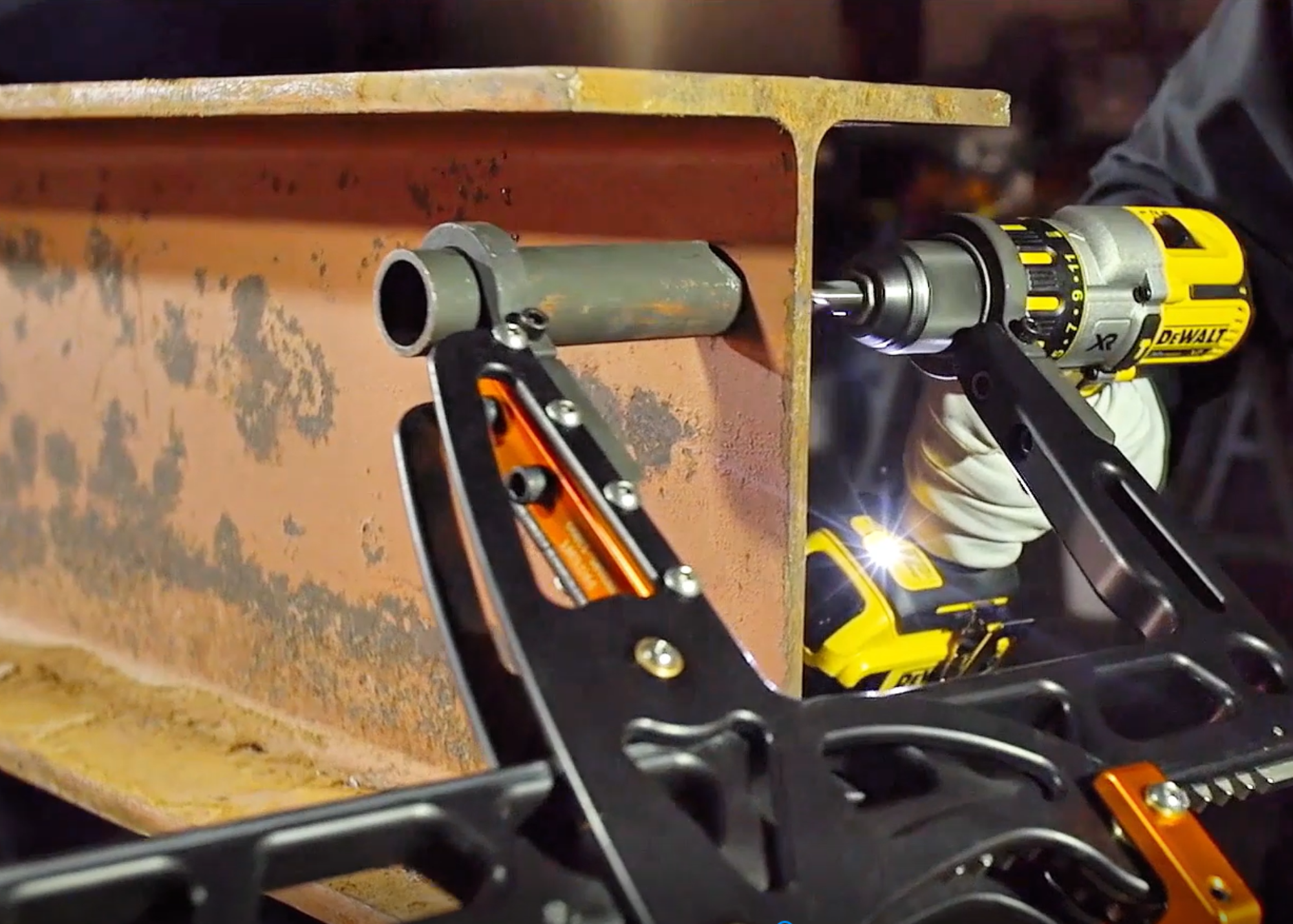 Load video: Assembly of the rapidrill and dewalt drill. A dewalt drill is inserted and the rapidrill and this mag drill alternative is used to clamp onto and drill a hole through a steel beam.